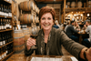 Flowell: Woman holding a glass of wine in a wine cellar
