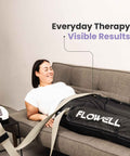 Flowell Prime Luxe Bundle - Woman wearing Flowell Home Pants set on a grey couch. Everyday therapy. Visible results