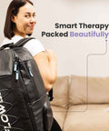 Flowell Prime Luxe Bundle - Woman wearing Flowell Pro Gear backpack in black and light blue. Smart therapy. Packed beautifully