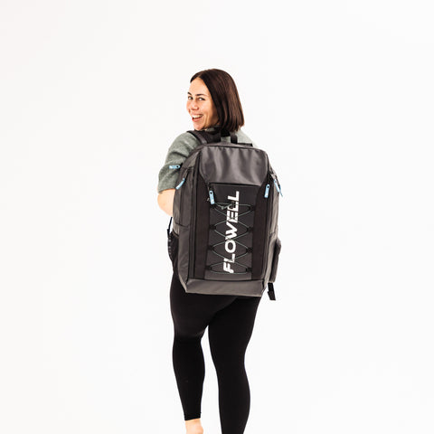 Flowell Pro Gear Backpack - Woman wearing Pro Gear Backpack in black and light blue over one shoulder