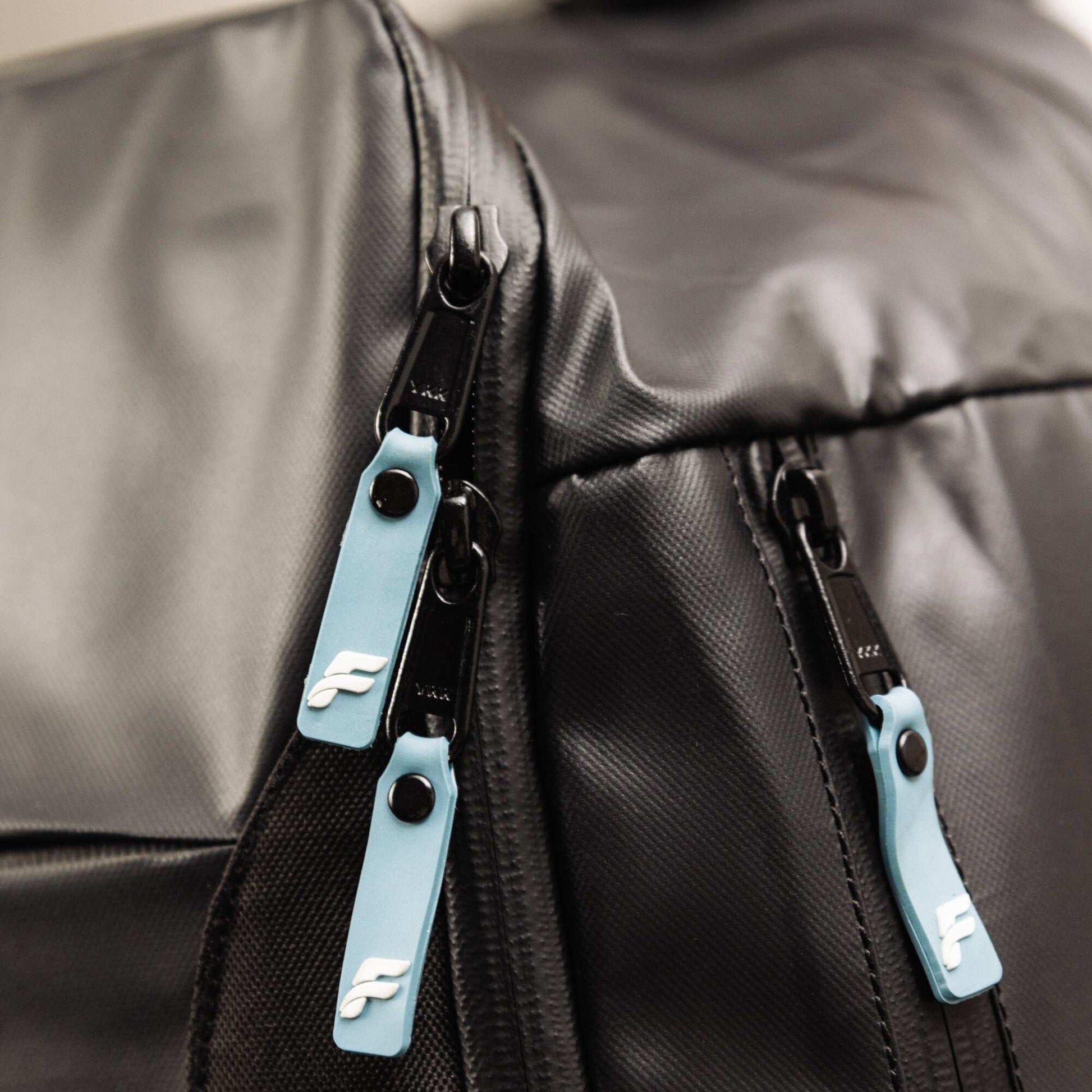 Flowell Pro Gear Backpack - Close up shot of Pro Gear Backpack's light blue and white zippers