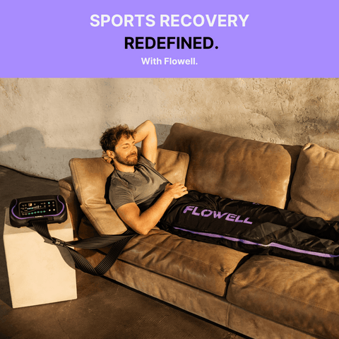 Flowell Sport Deluxe Pants Set - Man laying on couch wearing Flowell Sport Deluxe Pants Set in black and purple. Sports Recovery Redefined With Flowell