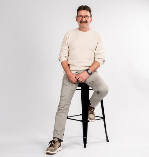 Flowell - Picture of our founder, Frank sitting on a stool and smiling to camera