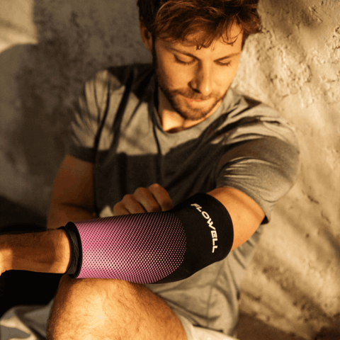 Flowell Thermosleeve - Man wearing purple and black Flowell thermosleeve on his elbow