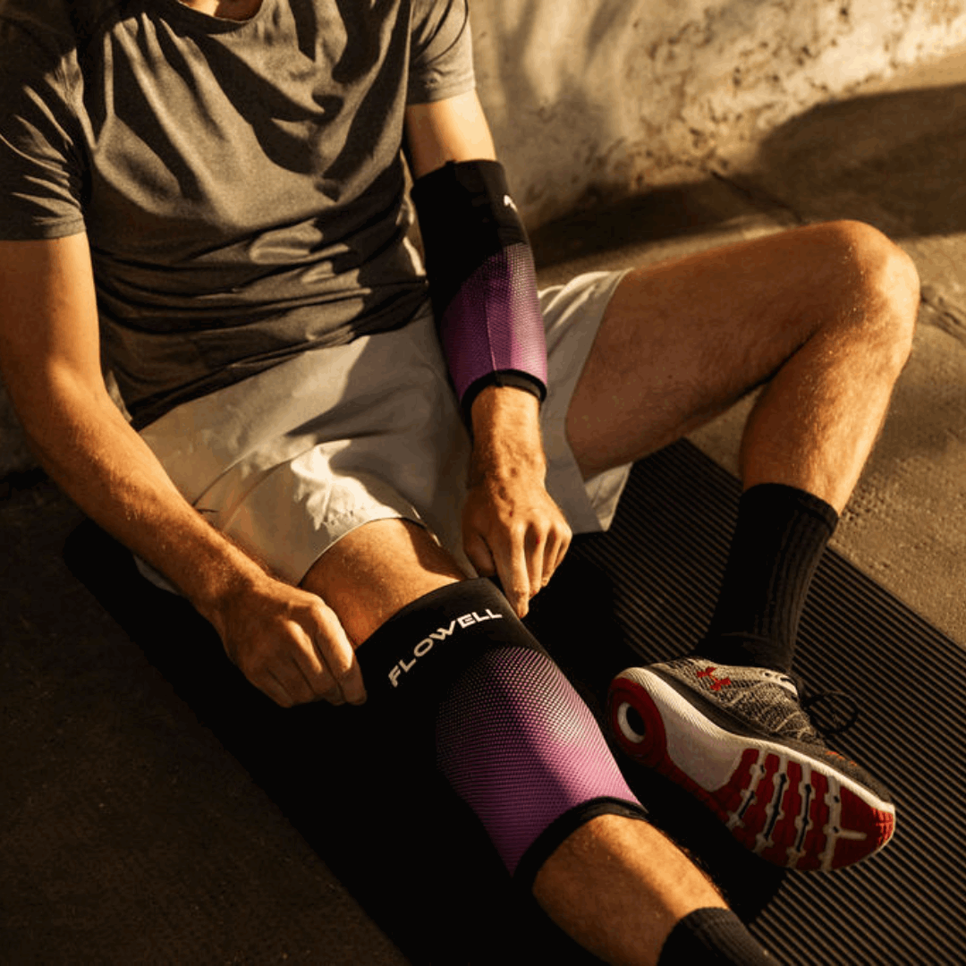 Flowell Thermosleeve - Man wearing purple and black Flowell thermosleeves on his elbow and his knee