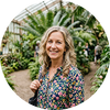 Flowell: Woman standing in a greenhouse with plants in the background
